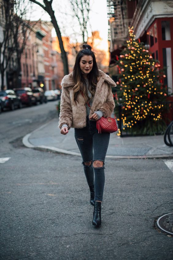 A faux fur jacket pairs perfectly with black skinnies, plain tee, and ankle boots. For more Faux Fur Styling ideas CLICK HERE