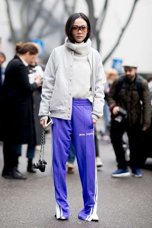 Lavender Outfit Ideas to Try in 2018: Two trends in one! We're loving lavender track pants paired back to an off white bomber jacket, turtleneck sweater and white shoes.