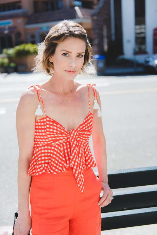 Everyday outfit ideas: Try gingham in a bold color like orange. We love this faithfull the brand tassel tie front top with ruffle detail