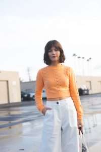 cream high waisted corduroy wide leg pant, orange knit sweater, cropped sweater, minimal style